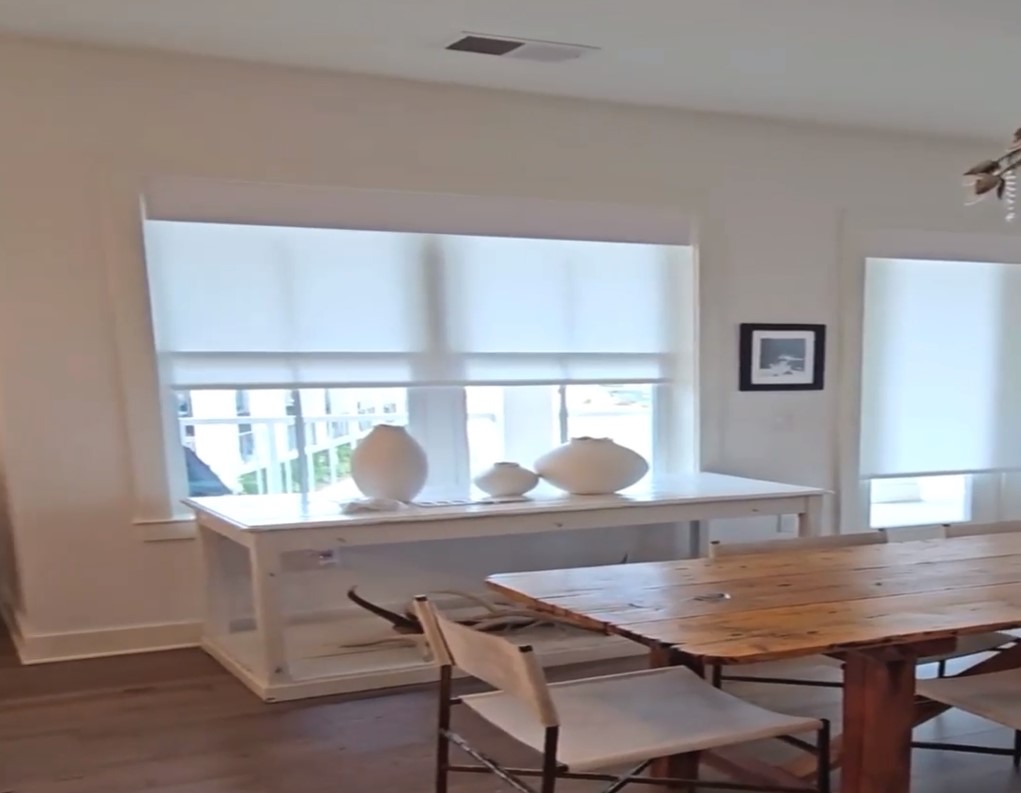 sheer shades rolling up on windows overlooking staircase using motorization